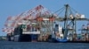 FILE - Container ships are docked at the Port of New York and New Jersey in Elizabeth, New Jersey, May 20, 2021.