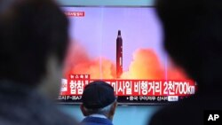 People watch a TV screen showing file footage of North Korea's missile launch, at the Seoul Railway Station in Seoul, South Korea, Aug. 29, 2017. 