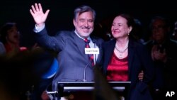 Alejandro Guillier, left, of the Nueva Mayoria coalition celebrates with his wife, Maria Cristina Farga, early results that place him second in the presidential election, in Santiago, Chile, Nov. 19, 2017.