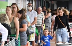 People line up to enter a grocery store before an impending lockdown due to an outbreak of the coronavirus disease in Brisbane, Australia, Jan. 8, 2021.