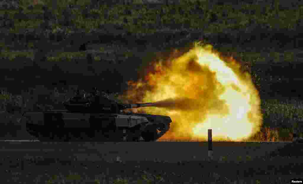 A T-72 B3 tank operated by a crew from Armenia fires during the Tank Biathlon competition at the International Army Games 2018 in Alabino outside Moscow, Russia.