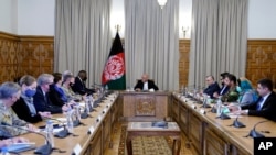 Afgan President Ashraf Ghani, center, meets with U.S. Defense Secretary Lloyd Austin, center left, and their delegations, at the presidential palace in Kabul, Afghanistan, March 21, 2021.