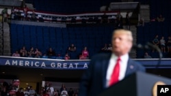 Supporters of President Donald Trump listen as he speaks at a campaign rally at the BOK Center, in Tulsa, Oklahoma, June 20, 2020. 