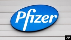 A sign in the window of an office at Pfizer Manufacturing in Puurs, Belgium, Dec. 21, 2020.