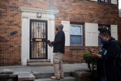 Volunteers conduct a door-knock campaign to provide information about where people can get their vaccinations and help answer questions related to hesitancy around the coronavirus vaccine in Detroit, Michigan, May 4, 2021.