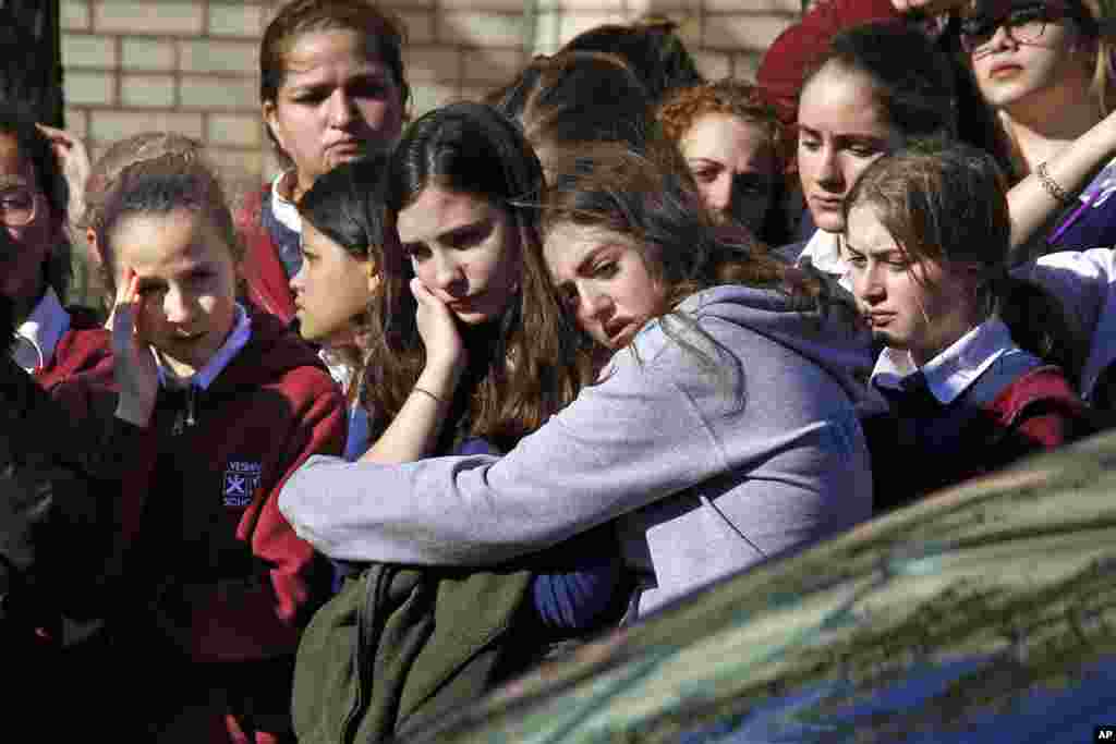 Students from the Yeshiva School in the Squirrel Hill neighborhood of Pittsburgh stand outside Beth Shalom Synagogue, after attending the funeral service for Joyce Fienberg. Fienberg, 75, Melvin Wax, 87, and Irving Younger, 69, were laid to rest as part of a weeklong series of services for the 11 people killed in a shooting Saturday at the Tree of Life synagogue.