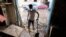 A man clears mud covering the floor of his pharmacy, which was affected by floods in Derna, Libya, Sept. 28, 2023. 
