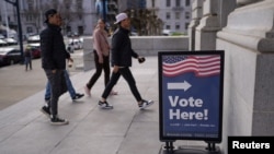 Voters cast their ballots during early voting at San Francisco City Hall