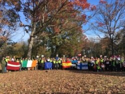 EU countries’ representatives joined National Park Service staff and volunteers from Casey Trees to plant oak, holly, tuliptree and American elm trees at Montrose Park in northwest Washington, Nov. 15, 2019. (Natalie Liu/VOA)