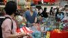 People line up to pay at a supermarket, amid the coronavirus disease outbreak in Kuala Lumpur, Malaysia, Jan. 12, 2021.
