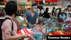 People line up to pay at a supermarket, amid the coronavirus disease outbreak in Kuala Lumpur, Malaysia, Jan. 12, 2021.