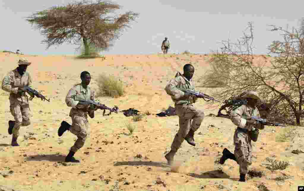 In this March 18, 2004, file photo. Malian soldiers from the 512th Motorised Infantry company complete their training by U.S. Special Forces in the desert near Timbuktu in Mali as part of the U.S. Pan-Sahel Initiative to secure the Sahel region from being
