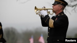 FILE - Taps is played by a lone bugler during the funeral for a Korean War veteran in Palmer, Tennessee, Jan. 12, 2013. 