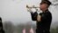 FILE - Taps is played by a lone bugler during the funeral for a Korean War veteran in Palmer, Tennessee, Jan. 12, 2013. 