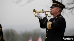 FILE - Taps is played by a lone bugler during the funeral for Korean War veteran Private First Class Glenn Schoenmann in Palmer, Tennessee, Jan. 12, 2013. 