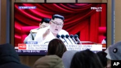 People watch a TV screen showing a file image of North Korean leader Kim Jong Un during a news program at the Seoul Railway Station in Seoul, South Korea, Jan. 1, 2020. 