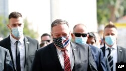 U.S. Secretary of State Mike Pompeo, center, wearing a mask, is seen during a walking tour of Dubrovnik's Old Town, Croatia, Oct. 2, 2020. Pompeo visited Croatia as part of his six-day trip to Southern Europe. 