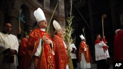 Christian clergymen carry palm fronds during the Palm Sunday procession in the Church of the Holy Sepulcher, traditionally believed by many to be the site of the crucifixion, in Jerusalem's Old City, March 20, 2016.