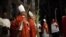Christian clergymen carry palm fronds during the Palm Sunday procession in the Church of the Holy Sepulcher, traditionally believed by many to be the site of the crucifixion, in Jerusalem's Old City, March 20, 2016.