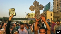 A Muslim woman holds a Quran during a show of solidarity with protesting Coptic Christians, Cairo, Egypt. October 10, 2011.