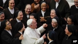 FILE - Pope Francis greets a group of nuns during his weekly general audience, in Paul VI Hall at the Vatican, Jan. 15, 2020.