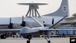 FILE - A Predator B unmanned aircraft taxis at the Naval Air Station in Corpus Christi, Texas, Nov. 8, 2011.