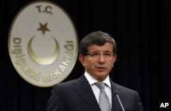 FILE - Turkish Foreign Minister Ahmet Davutoglu addresses the media in Ankara, Aug. 15, 2011