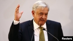 Mexico's President Andres Manuel Lopez Obrador gestures during a meeting with industry bosses and members of his cabinet to discuss the new administration's policy on the minimum wage at National Palace in Mexico City, Mexico, Dec. 17, 2018. 