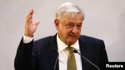 Mexico's President Andres Manuel Lopez Obrador gestures during a meeting with industry bosses and members of his cabinet to discuss the new administration's policy on the minimum wage at National Palace in Mexico City, Mexico, Dec. 17, 2018. 