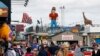 People walk along a rebuilt portion of boardwalk a year afer it was destroyed by Superstorm Sandy, Seaside Heights, New Jersey, Oct. 13, 2013.<br />
