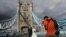 Tony Cao and Jenny Nguyen from Vietnam pose for wedding photos on the Tower Bridge, in London. Some daters insist on safety precautions before leaping into off-screen meetups. A lucky few are on the ultimate step, marriage.