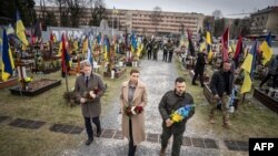 FILE - Denmark's Prime Minister Mette Frederiksen (C) and Ukraine's President Volodymyr Zelensky (R) lay flowers at a memorial ceremony at the Field of Mars of Lychakiv Cemetery, in Lviv, on February 23, 2024, on the eve of the second anniversary of Russia's invasion on Ukraine.