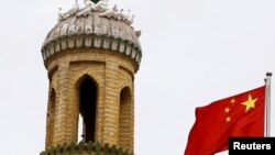 Bendera nasional China berkibar di dekat menara Masjid Id Kah di Kota Tua di Kashgar, Daerah Otonomi Xinjiang Uighur, China, 6 September 2018.
(Foto: dok).