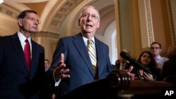 Senate Majority Leader Mitch McConnell, R-Ky., joined at left by Sen. John Barrasso, R-Wyo., speaks to reporters about the political battle for confirmation of President Donald Trump's Supreme Court nominee, Brett Kavanaugh, following a closed-door GOP po