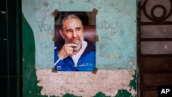 FILE - A poster of Cuban Revolution leader Fidel Castro hangs on a wall in Havana, Cuba, Aug. 13, 2016.