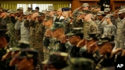 U.S. and Philippine troops salute during the opening ceremony of their joint military exercise dubbed "Balikatan 2015" at Camp Aguinaldo at suburban Quezon city, northeast of Manila, Philippines, April 20, 2015.