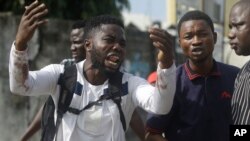 Alister, a protester who says his brother Emeka died from a stray bullet from the army, reacts while speaking to the Associated Press near Lekki toll gate in Lagos, Nigeria, Oct. 20, 2020. (AP)