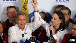 Venezuelan opposition leader Maria Corina Machado talks to the media, accompanied by opposition presidential candidate Edmundo Gonzalez Urrutia, following the presidential election results in Caracas on July 29, 2024.