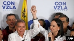 Venezuelan opposition leader Maria Corina Machado talks to the media, accompanied by opposition presidential candidate Edmundo Gonzalez Urrutia, following the presidential election results in Caracas on July 29, 2024.