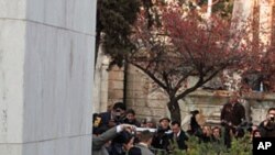 Workers carry the exhumed casket of former Chilean president Salvador Allende from his tomb in Santiago, May 23, 2011