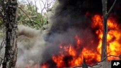 FILE—In this photo from October 12, 2004, an oil pipeline fire burns near the village of Goi in Nigeria. A Dutch appeals court February 12, 2021, ordered Shell’s Nigerian subsidiary to pay farmers for damage to their land caused by a pair of oil leaks more than 15 years earlier.