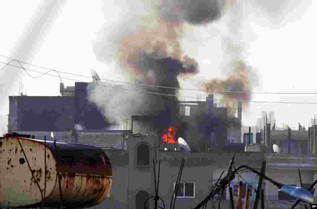Black smoke rises into the air from relentless Syrian government shelling of the Baba Amr neighborhood in Homs province. (AP/Local Coordination Committees in Syria)
