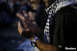 FILE - People pray as they take part in a pro-Palestinian protest, after hundreds of Palestinians were killed in a blast at Al-Ahli hospital in Gaza that Israeli and Palestinian officials blamed on each other, in Amman, Jordan, October 18, 2023.