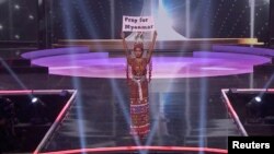 Ma Thuzar Wint Lwin, Miss Universe Myanmar, holds up the "Pray for Myanmar" sign during Miss Universe pageant's national costume show, in Hollywood, Florida, U.S., May 13, 2021 in this screengrab taken from a handout video. Courtesy MISS UNIVERSE/Handou