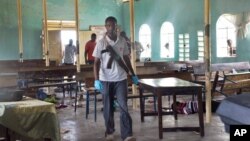 An armed Kenyan policeman walks inside the African Inland Church in Garissa, July 1, 2012. 