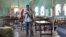 An armed Kenyan policeman walks inside the African Inland Church in Garissa, July 1, 2012. 