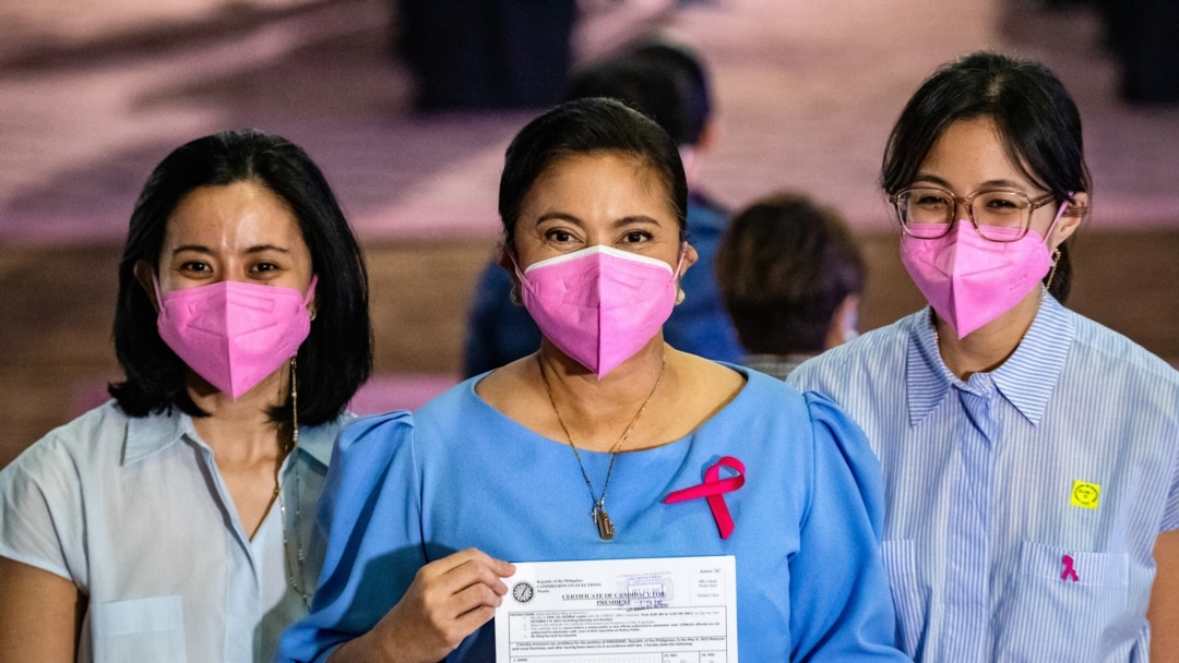 Philippines' Vice President Leni Robredo poses with her daughters Aika and Tricia after filing her certificate of candidacy for president in the 2022 national election, in Pasay City, Metro Manila, Philippines, Oct. 7, 2021. (Ezra Acaya/Pool via Reuters) 