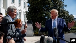 President Donald Trump talks to reporters on the South Lawn of the White House, Oct. 4, 2019.