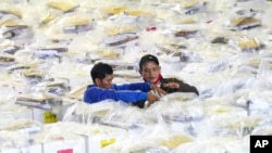 Workers prepare ballot boxes to be distributed to polling stations ahead of the Feb. 14 election, in Jakarta, Indonesia, Feb. 13, 2024. 