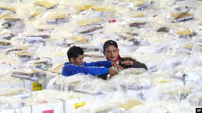 Workers prepare ballot boxes to be distributed to polling stations ahead of the Feb. 14 election, in Jakarta, Indonesia, Feb. 13, 2024.